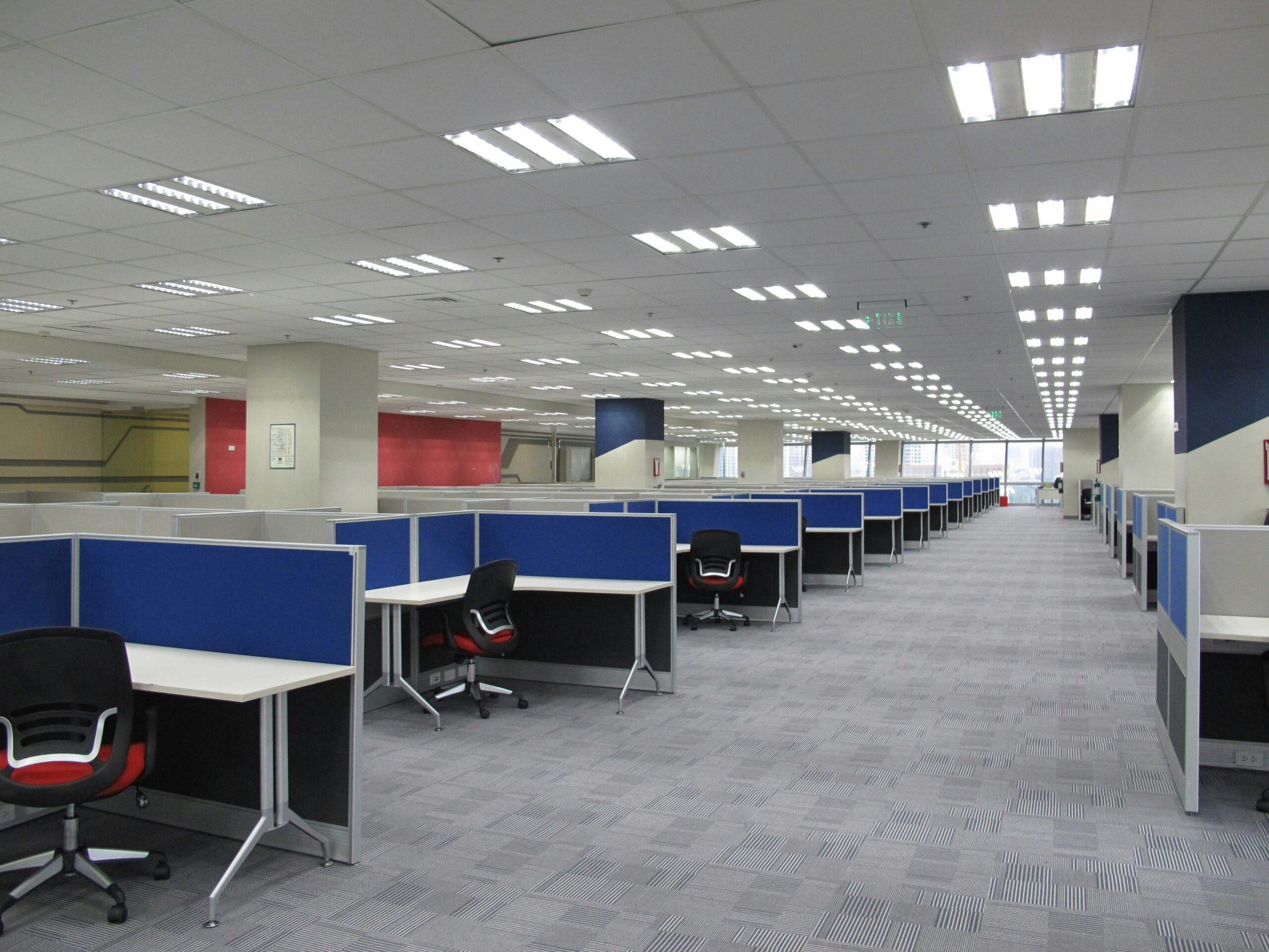 Modern office pods in an open-plan workspace, providing quiet, private areas for employees to focus and hold confidential meetings.