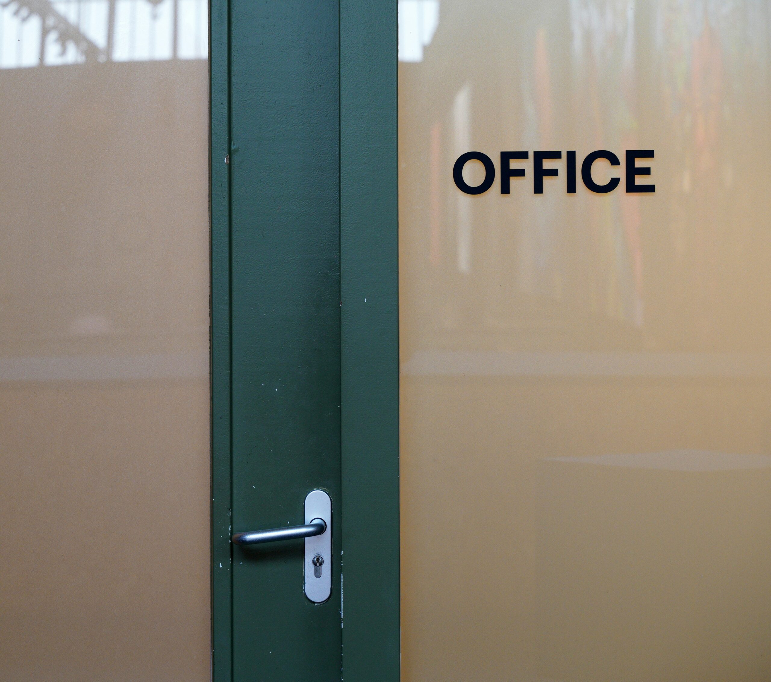 Close-up of a misaligned office pod door and worn acoustic seals during Office Pod Servicing in a corporate workspace.